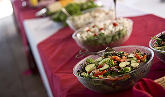 A buffet table full of catered food