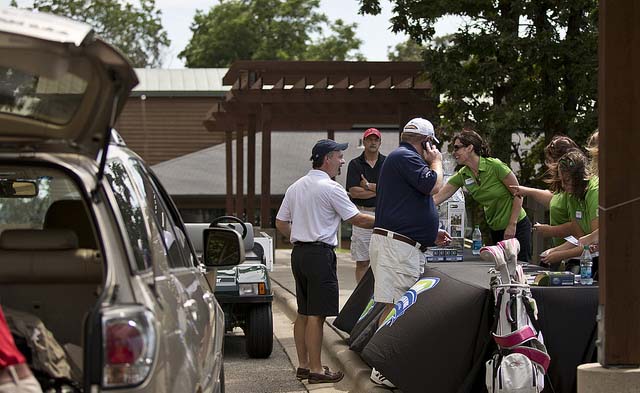 A group setting up for a golf outing
